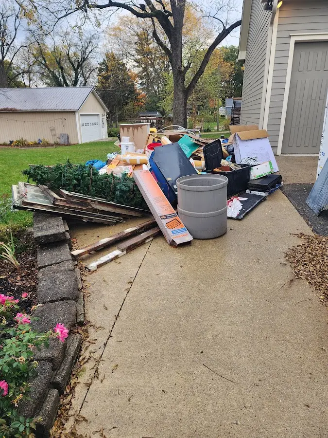Dumpster being loaded with debris for Commercial Dumpster Rental in Port Richey